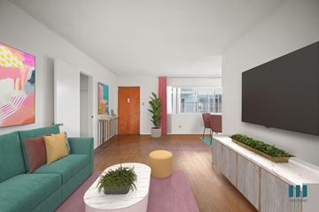Los Angeles apartment for rent - A living room with a green couch, a yellow coffee table, and a large painting on the wall.