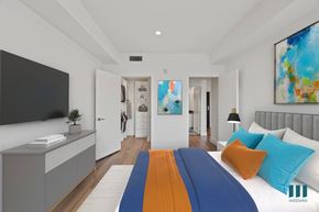 Los Angeles apartment for rent - A modern bedroom with a large bed and a painting on the wall.