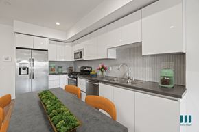 Los Angeles apartment for rent - A modern kitchen with a long table and chairs.