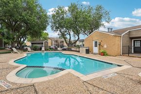 Houston apartment for rent - A small pool surrounded by a stone patio.