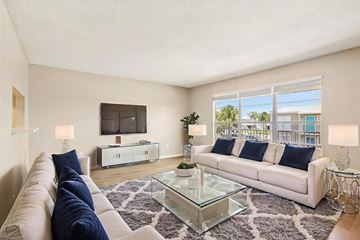 Daytona Beach apartment for rent - A living room with a white couch and a glass coffee table.