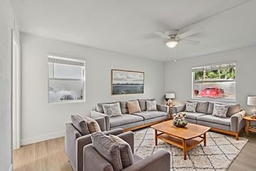 New Smyrna Beach apartment for rent - A living room with grey couches and a wooden coffee table.