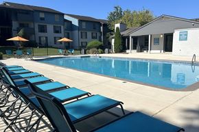 Birmingham apartment for rent - A pool with sun loungers in front of a building at Crestwood Green Apartments, Birmingham, Alabama