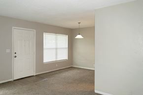 Daytona Beach apartment for rent - a living and dining area with overhead lighting and natural light from windows