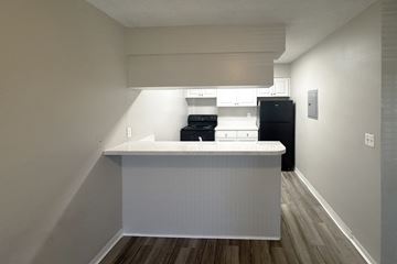 Daytona Beach apartment for rent - A kitchen with a white counter and black appliances.
