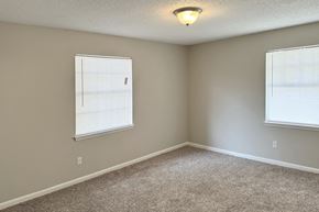 Birmingham apartment for rent - an spacious bedroom with two windows and a carpeted floor at Spring Lake Cove Apartments, Birmingham, AL 35215