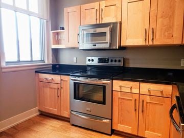 South Bend condo for rent - a kitchen with stainless steel appliances and wooden cabinets