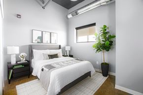 South Bend apartment for rent - a bedroom with a white bed and a potted plant