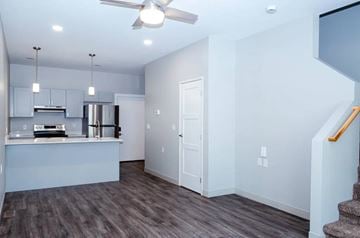 Plymouth apartment for rent - A kitchen with a stainless steel refrigerator and a ceiling fan.
