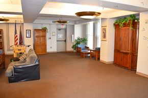 Indianapolis apartment for rent - A room with a black couch and a wooden cabinet.