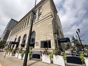 South Bend condo for rent - an old stone building with potted plants in front of it
