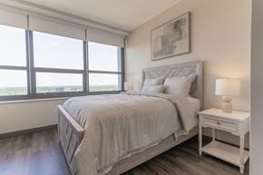 South Bend apartment for rent - A bedroom with a large bed and a window overlooking the water.