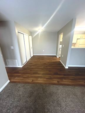Columbia City apartment for rent - A long hallway with wood floors and white walls.
