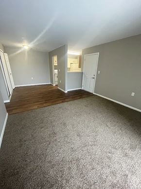 Columbia City apartment for rent - A room with a carpeted floor and a door on the right side.