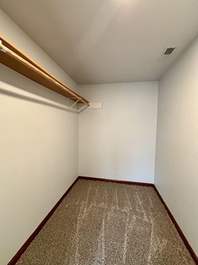 South Bend apartment for rent - A room with a carpet and a white wall.