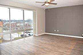 Plymouth apartment for rent - an empty living room with a large window and a ceiling fan