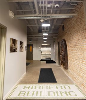 South Bend apartment for rent - a hallway with brick walls and a rug in the center of the floor