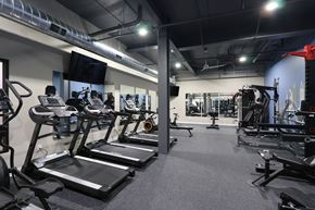 South Bend apartment for rent - a gym filled with cardio equipment and weights