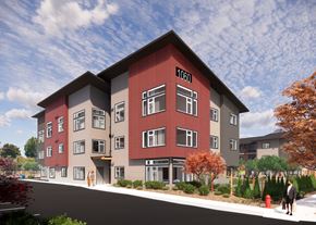 Marysville apartment for rent - A red and grey apartment building with the number 1060 on the front.