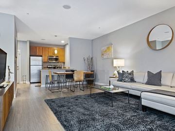 Chelsea apartment for rent - a living room and kitchen with a couch and a table