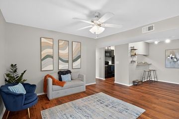 Nashville apartment for rent - A living room with a blue chair and a grey couch.