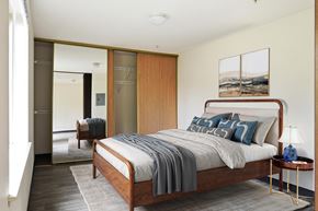 Bellingham apartment for rent - A bedroom with a bed, a nightstand, and a chair.