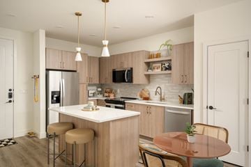 Farmers Branch apartment for rent - A kitchen with a refrigerator, microwave, and oven.