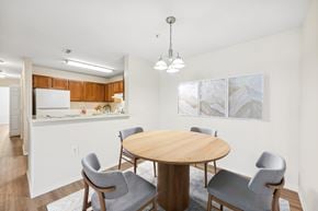 Woodbridge apartment for rent - A dining room with a round table and grey chairs.