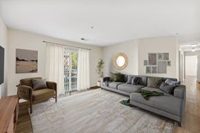 Woodbridge apartment for rent - A living room with a grey couch and a wooden table.