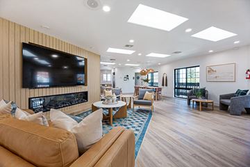 Encinitas apartment for rent - A living room with a large television and comfortable seating.