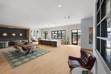 Broomfield apartment for rent - A modern living room with a brown leather chair and a fireplace.