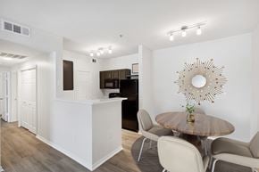 San Antonio apartment for rent - A modern dining room with a wooden table and chairs.