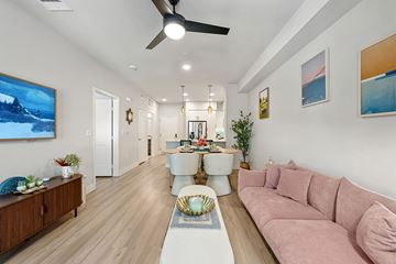 Camarillo apartment for rent - A living room with a pink couch and a painting on the wall.