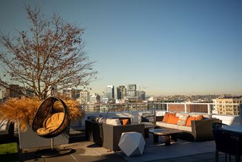 Expansive rooftop lounge with fireplace and skyline views