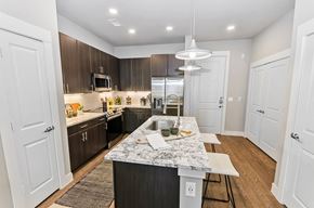 Plano apartment for rent - Marble kitchen island at Opal Legacy Central in Plano TX