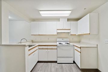 Kirkland apartment for rent - a white kitchen with white appliances and white cabinets