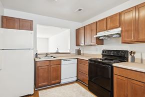 Chester apartment for rent - A kitchen with a black stove top oven and white appliances.