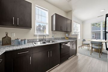 Chester apartment for rent - A kitchen with dark brown cabinets and a granite countertop.