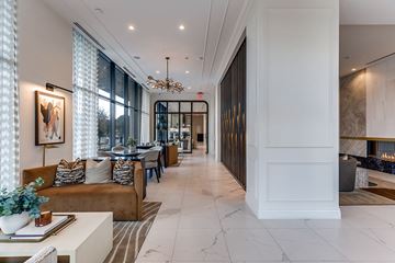 Houston apartment for rent - A modern living room with a brown sofa and a chandelier.