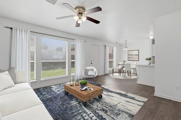 Channelview apartment for rent - A living room with a white couch and a ceiling fan.