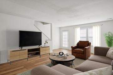 Chester apartment for rent - A living room with a brown leather chair and a black television.
