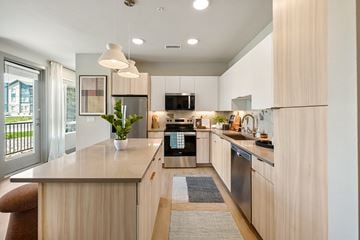 Broomfield apartment for rent - A modern kitchen with wooden cabinets and a large island.