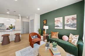Broomfield apartment for rent - A living room with a green couch, a wooden table, and a pineapple on the table.