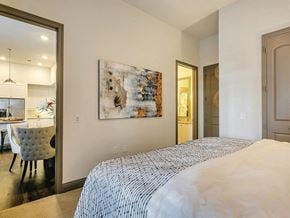 Plano apartment for rent - Model Bedroom with living room view at The Huntington Apartments in Plano TX
