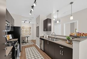 San Jose apartment for rent - A modern kitchen with dark brown cabinets and a black refrigerator.