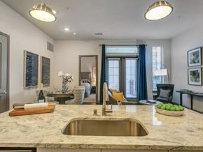 Plano apartment for rent - Model Kitchen Island at The Huntington Apartments in Plano TX