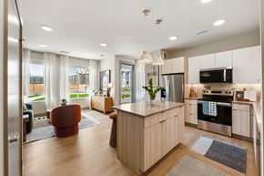 Broomfield apartment for rent - A modern kitchen with a large island and stainless steel appliances.