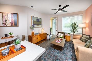 San Diego apartment for rent - A living room with a white table and a blue rug.