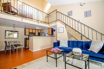 Longmont apartment for rent - A living room with a blue couch and a glass coffee table.