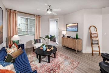 Poway apartment for rent - A living room with a blue couch and a coffee table.